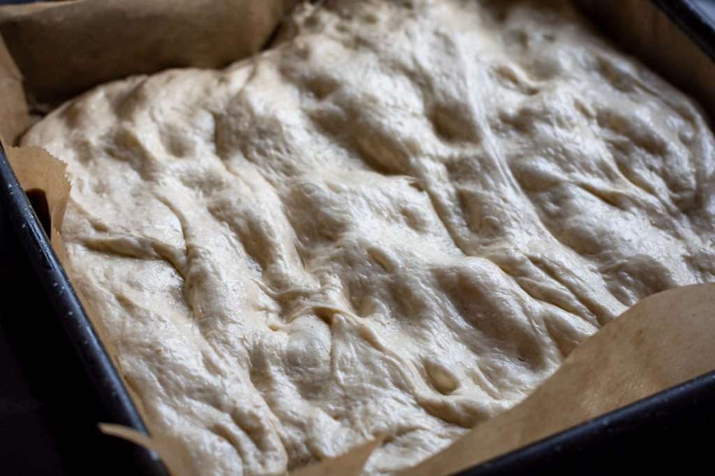 Filled almond focaccia stretched our to fit the baking tray.