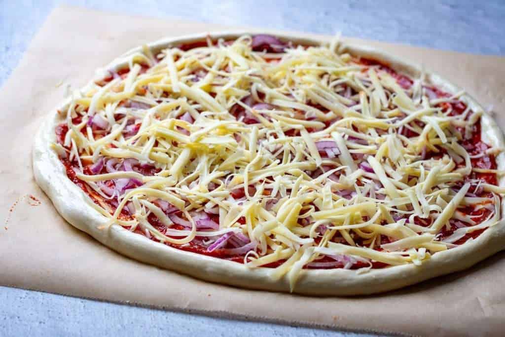 Grated cheese scattered on top of the pizza.