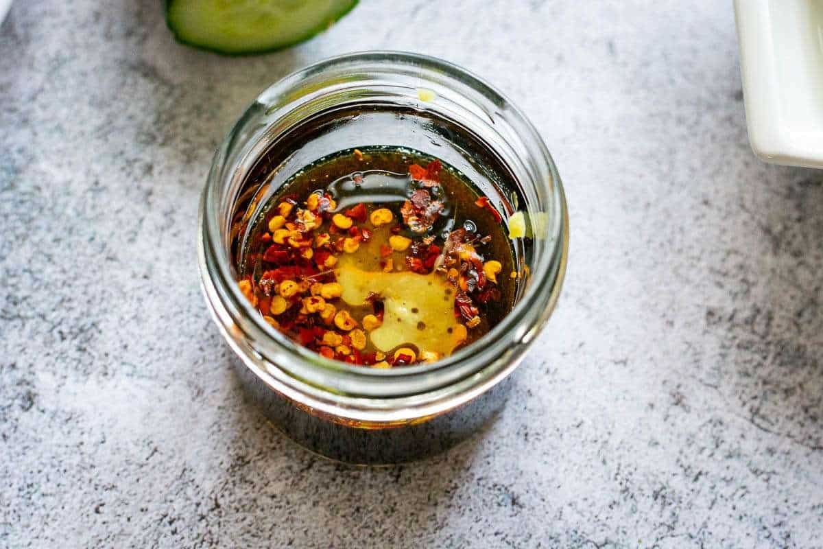 Ponzu style salad dressing for tuna poke bowls in a small glass jar.