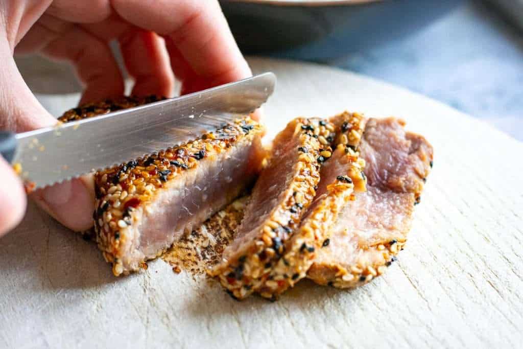 Slicing seared tuna steak against the grain.