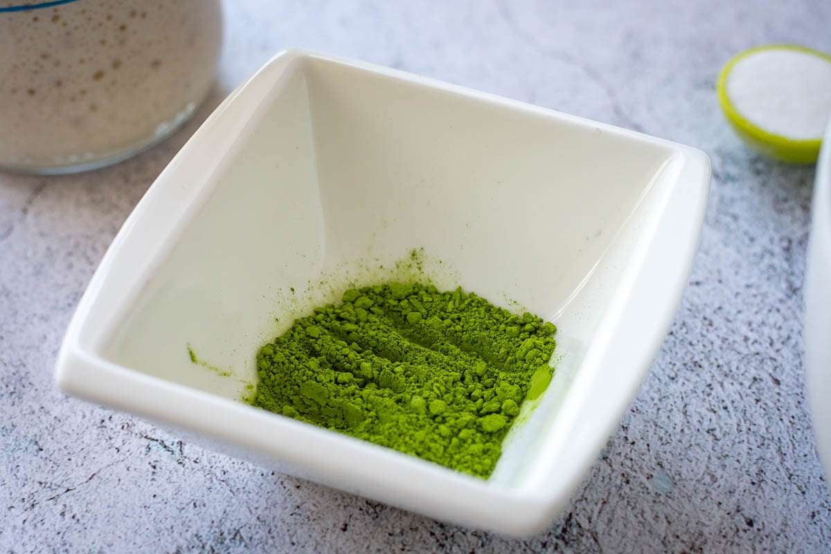 Matcha powder in a small white bowl.
