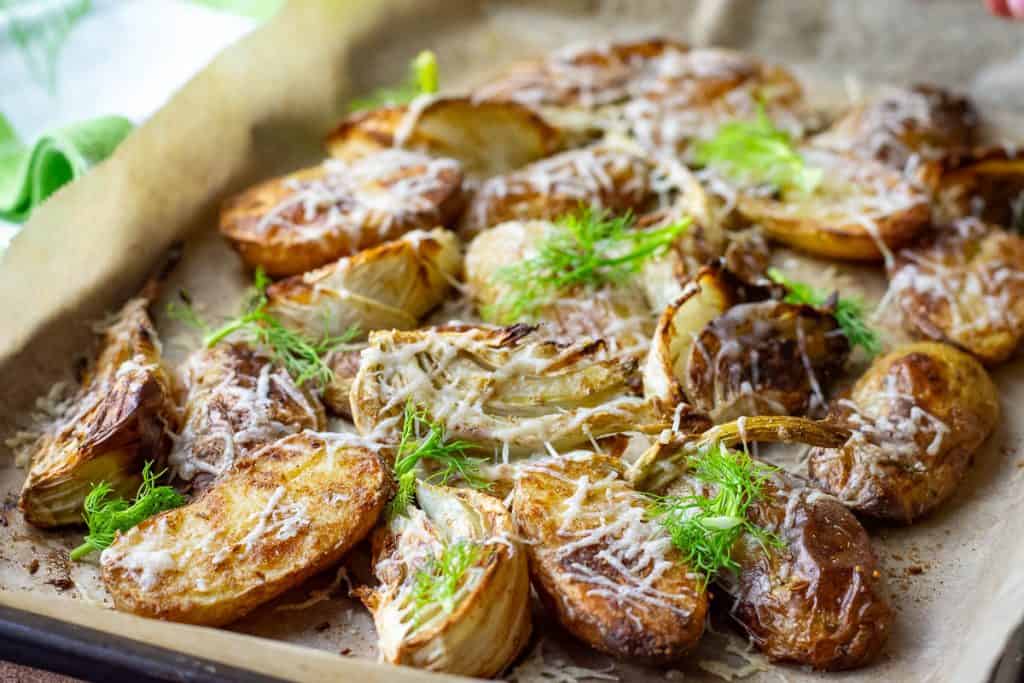 Roasted potatoes with fennel garnished with fronds.