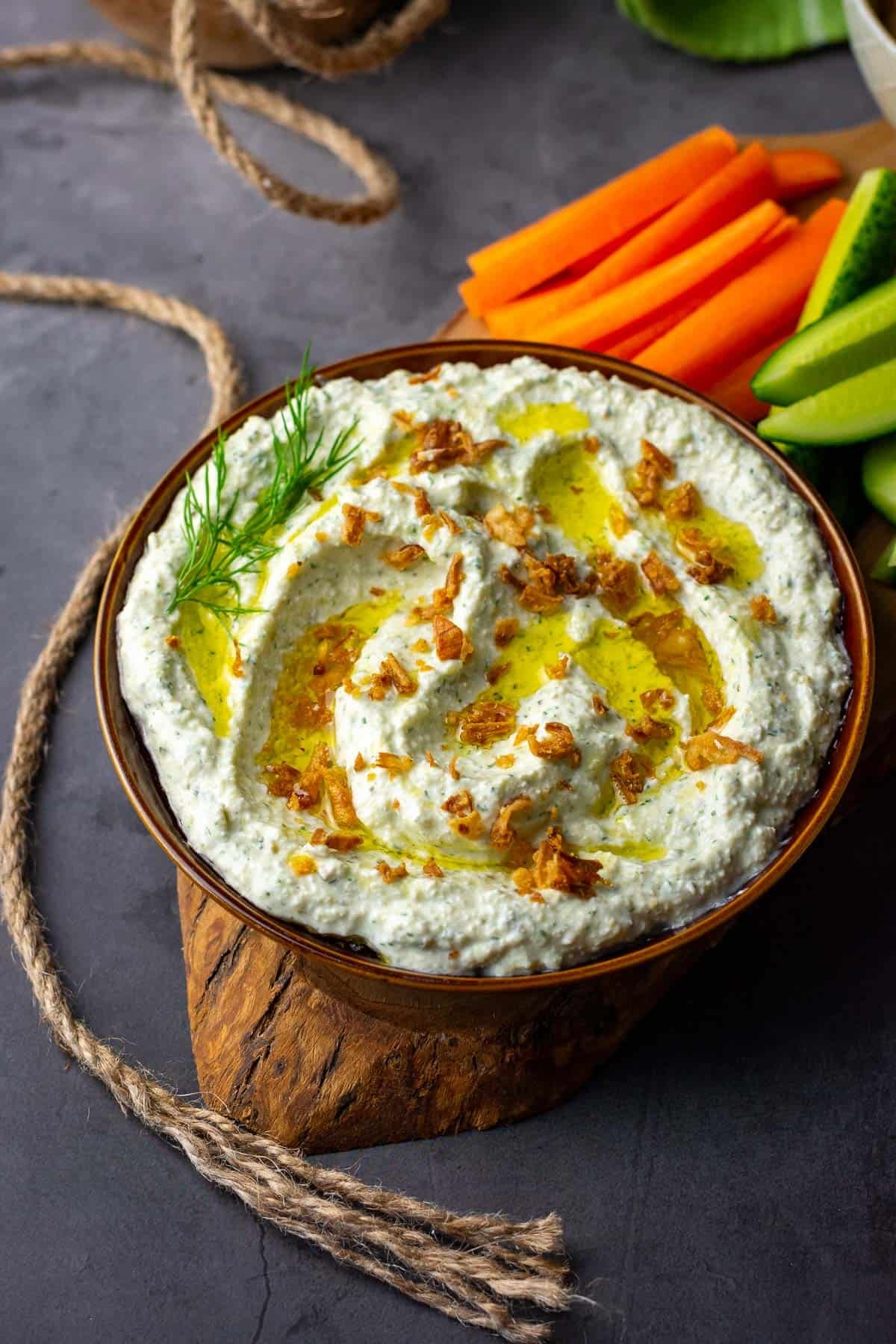 Dill Pickle Dip in a palte with a drizzle of oil.