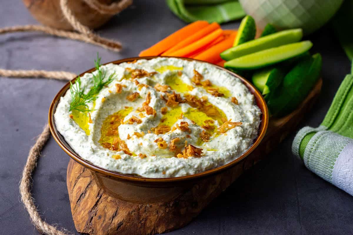 Cottage Cheese Pickle Dip on a wooden board.