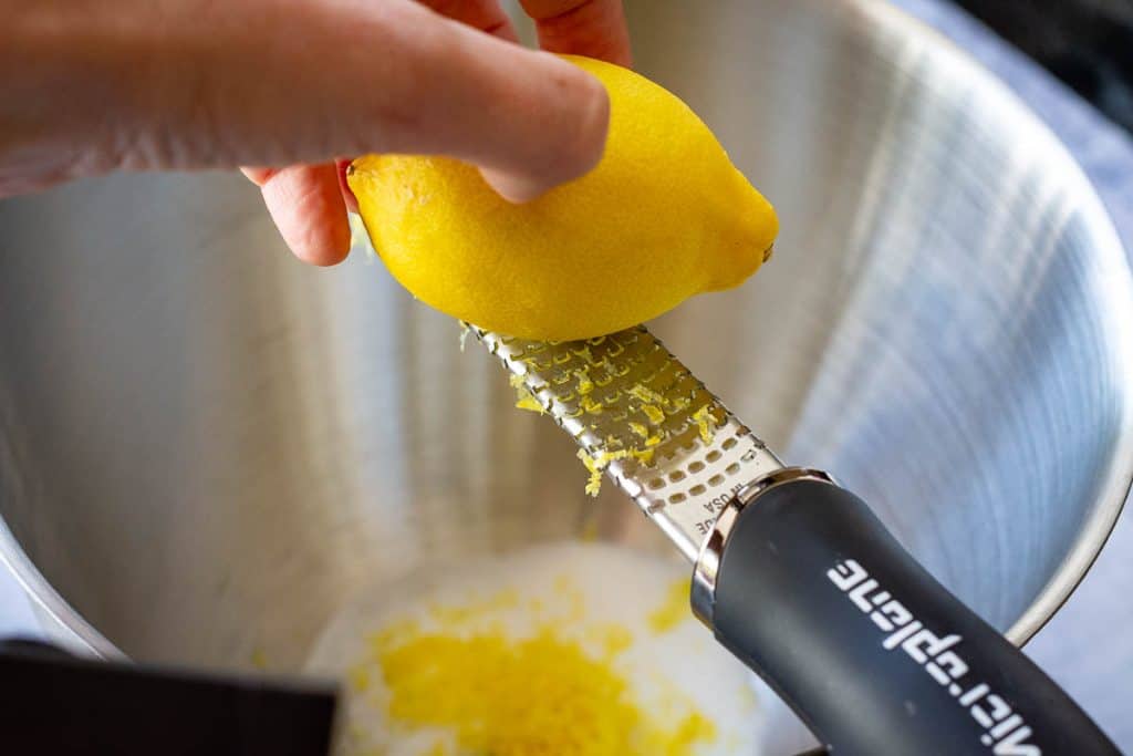 Using a microplane to zest the lemons.