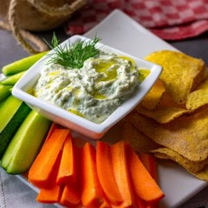 Cottage Cheese Pickle Dip on a plate with lots of veggies