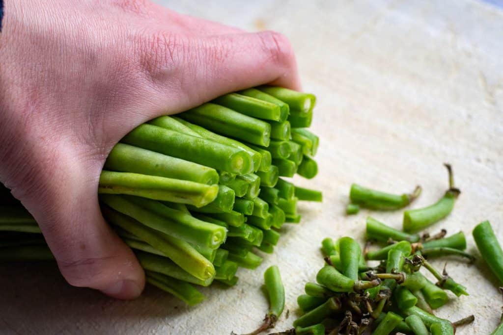 Trimming the ends of French green beans.