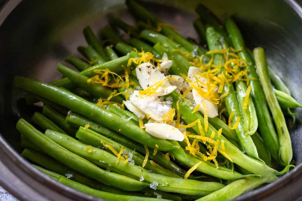 Green beans mixed with garlic and lemon zest.