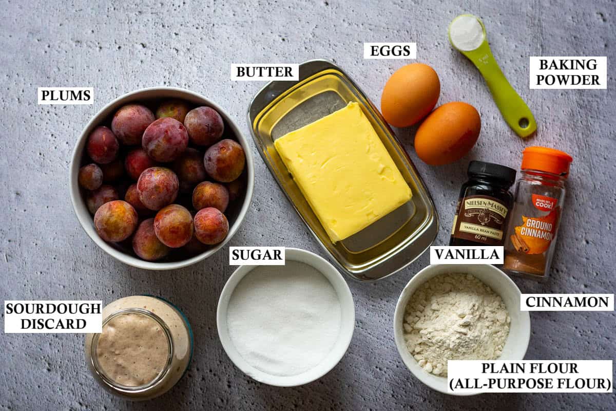 Ingredients for German Sourdough Plum Cake on grey surface.
