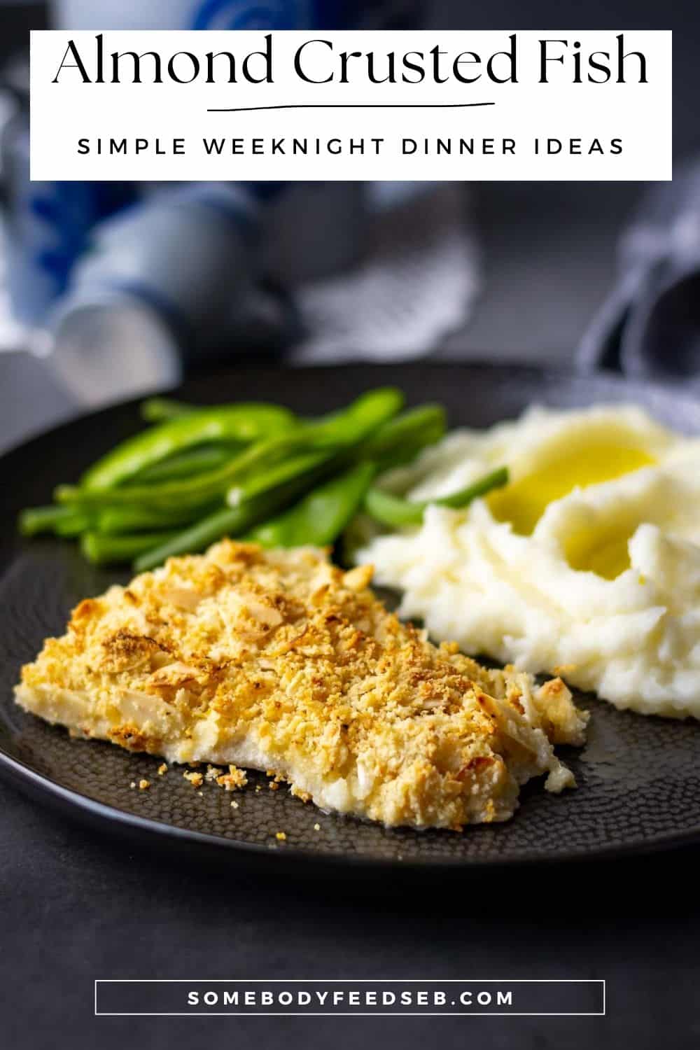 Almond Crusted Fish on a black plate with mashed potato and green beans. - Pin for Pinterest.