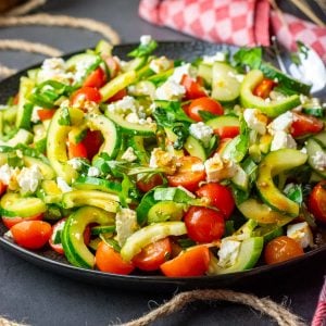 A large plateful of cucumber, tomato and feta salad.