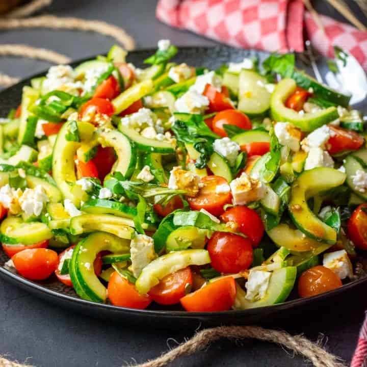 A large plateful of cucumber, tomato and feta salad.