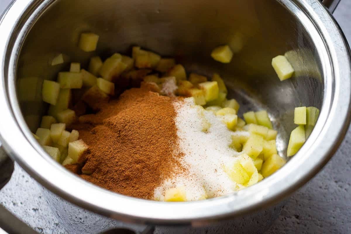 All cinnamon apple ingredients in a small pan.
