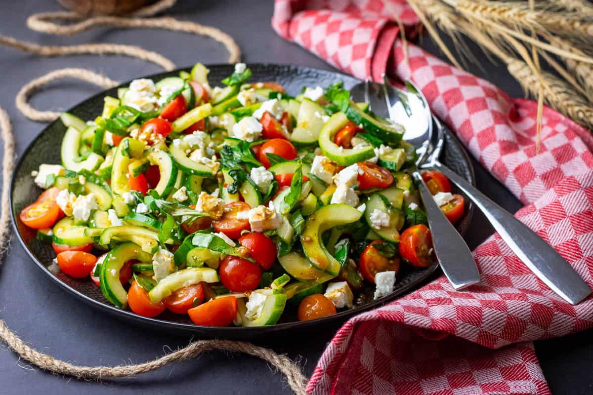 A large plateful of cucumber, tomato and feta salad.