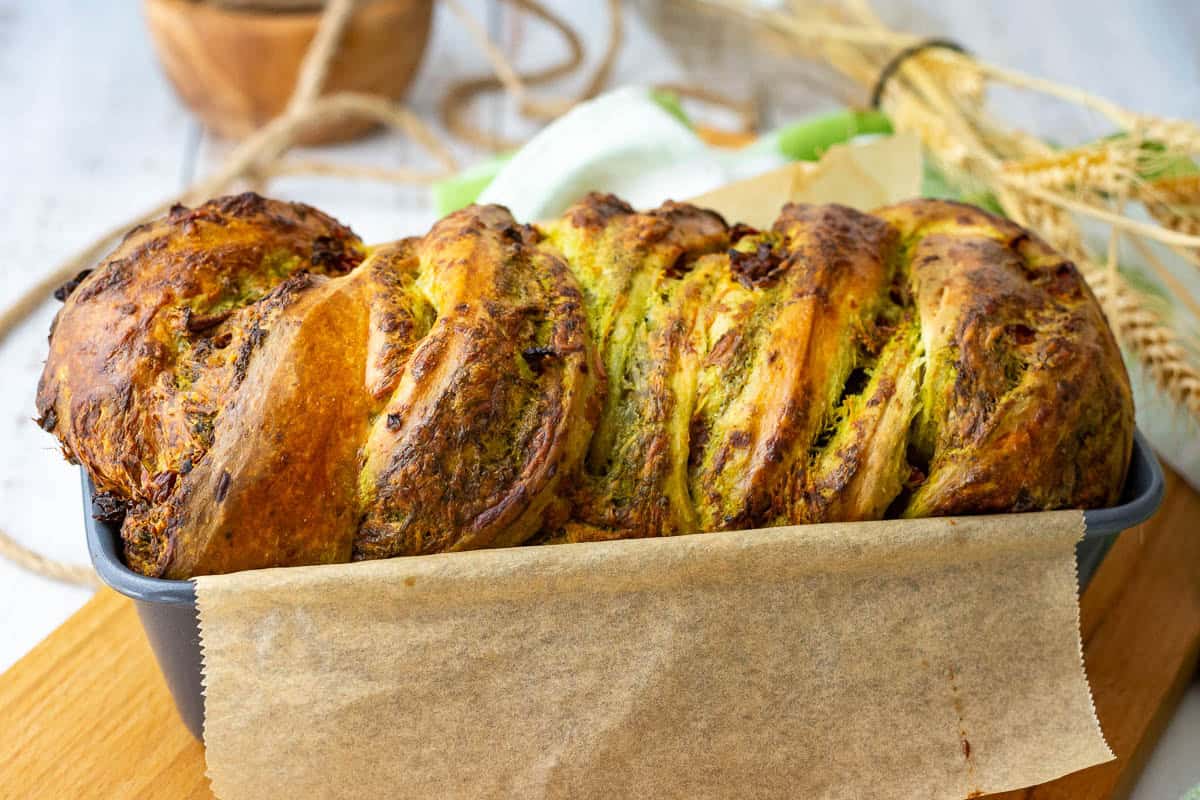 Sourdough Pesto Babka fresh out the oven still in a loaf tin.