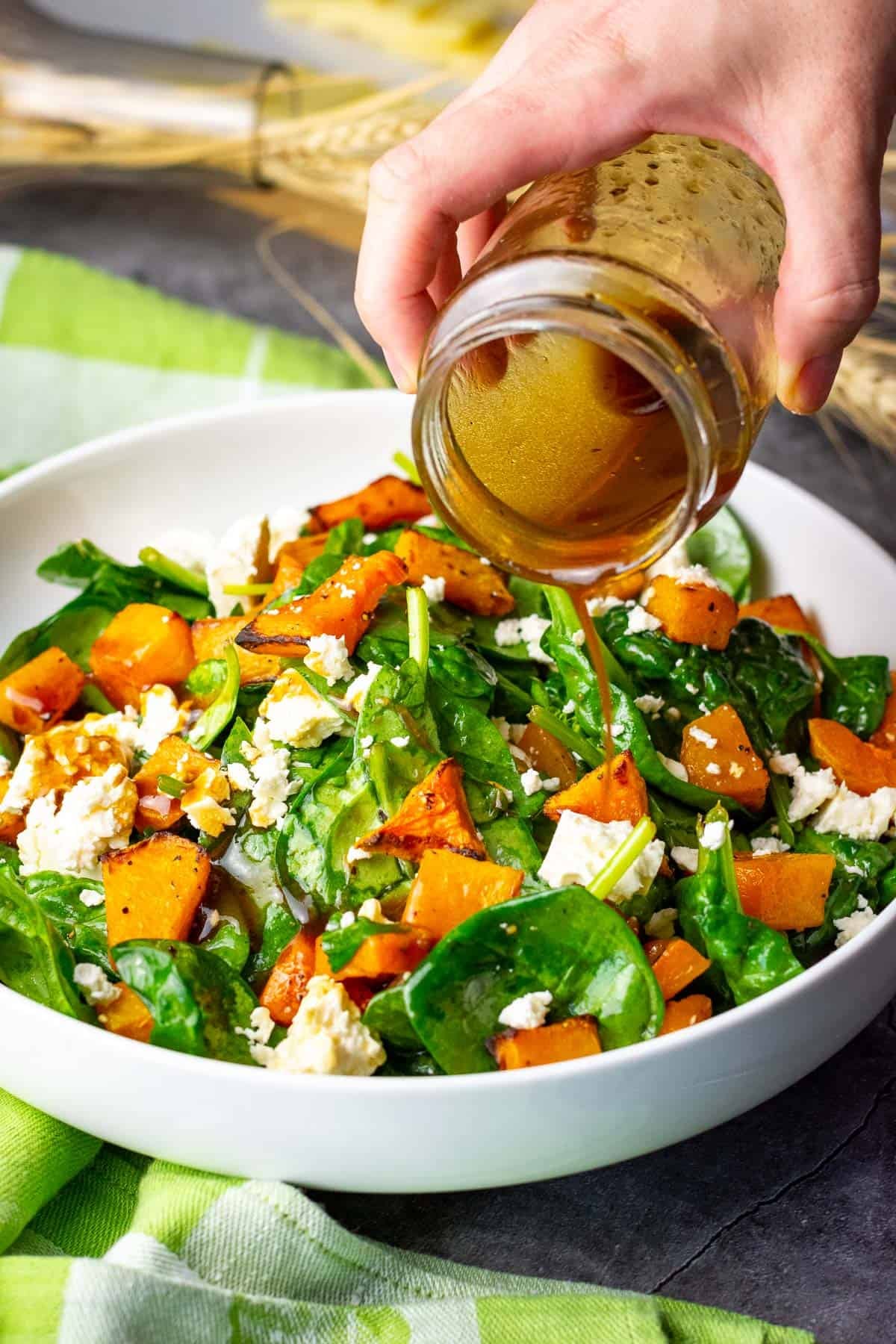Drizzling butternut squash and feta salad with balsamic dressing.