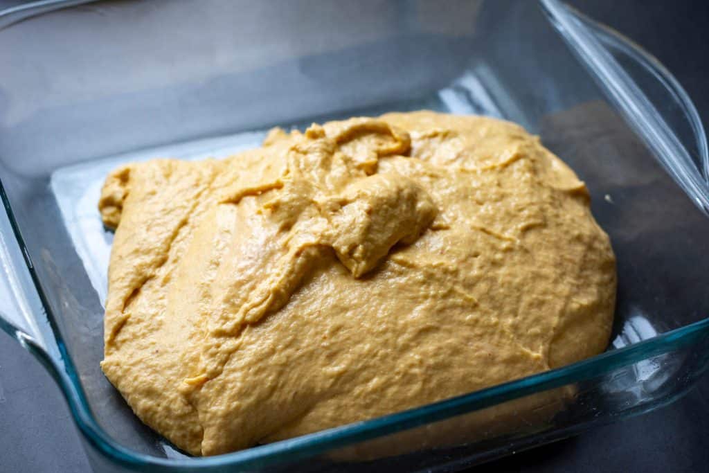 Pumpkin sourdough in a glass dish right after mixing.
