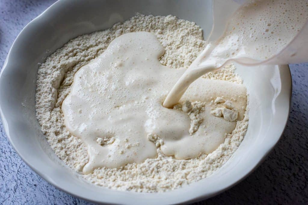 Pouring the milk and discard mixture into dry ingredients.