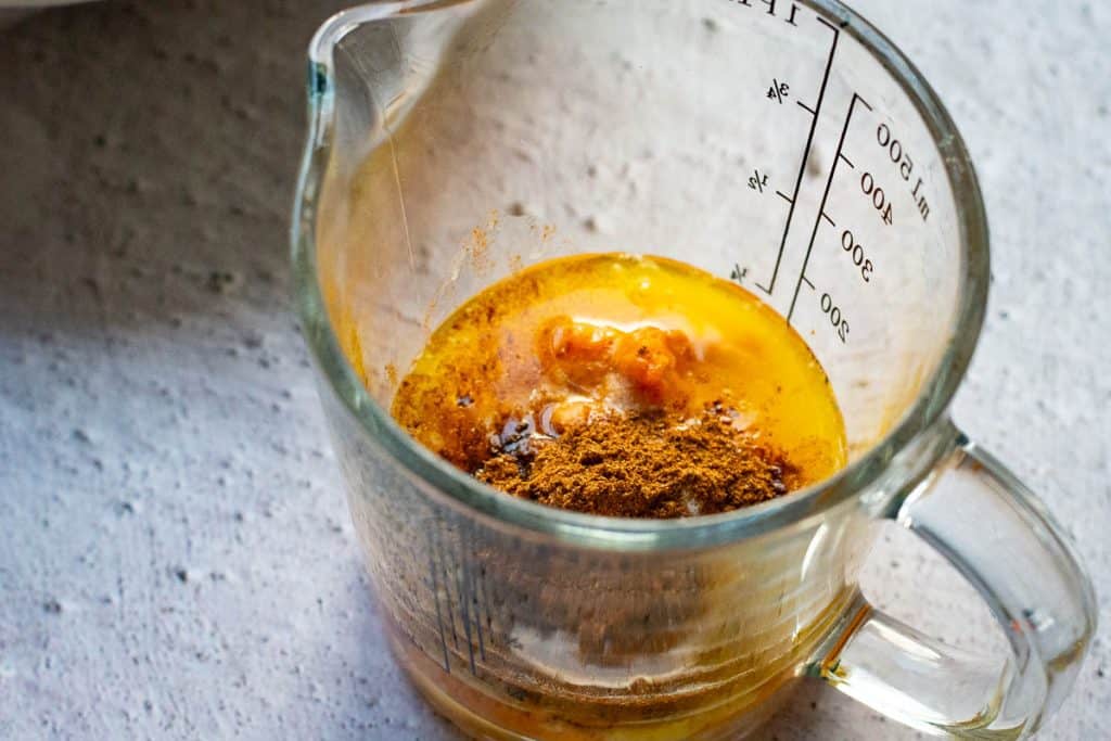 Pumpkin puree mixture in a galss jug.