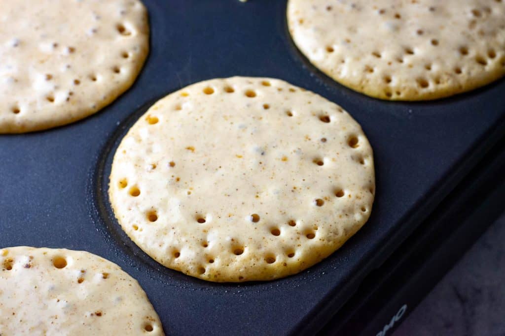 Bubbles coming up to the sourodugh pumpkin pancake surface before flipping.