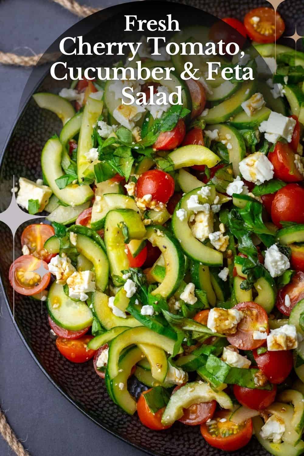 Cucumber, Tomato and Feta Salad on a large black plate - Pin for Pinterest.