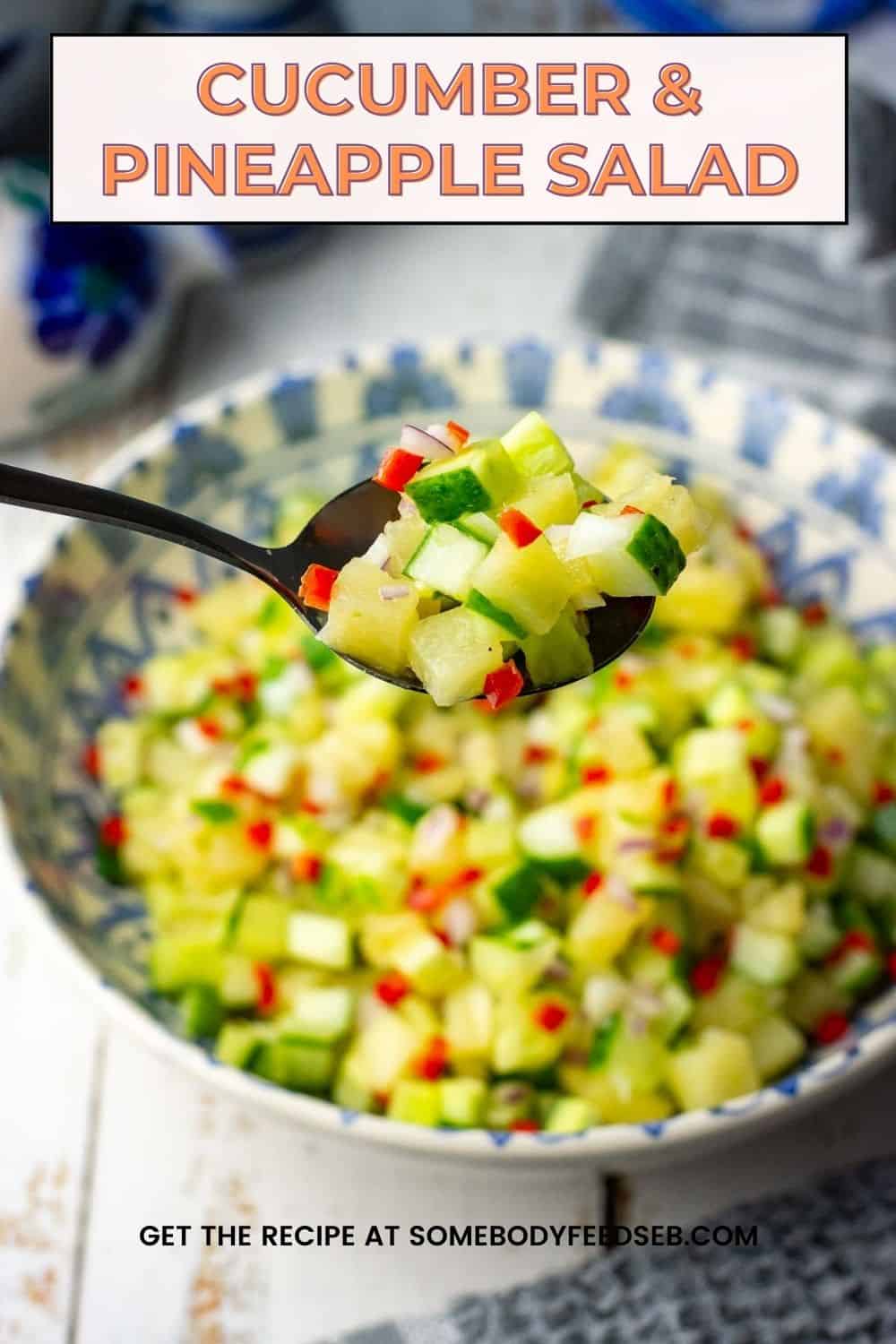 A spoonful of cucumber and pineapple salad lifted out of the bowlful of it. Pin for Pinterest.
