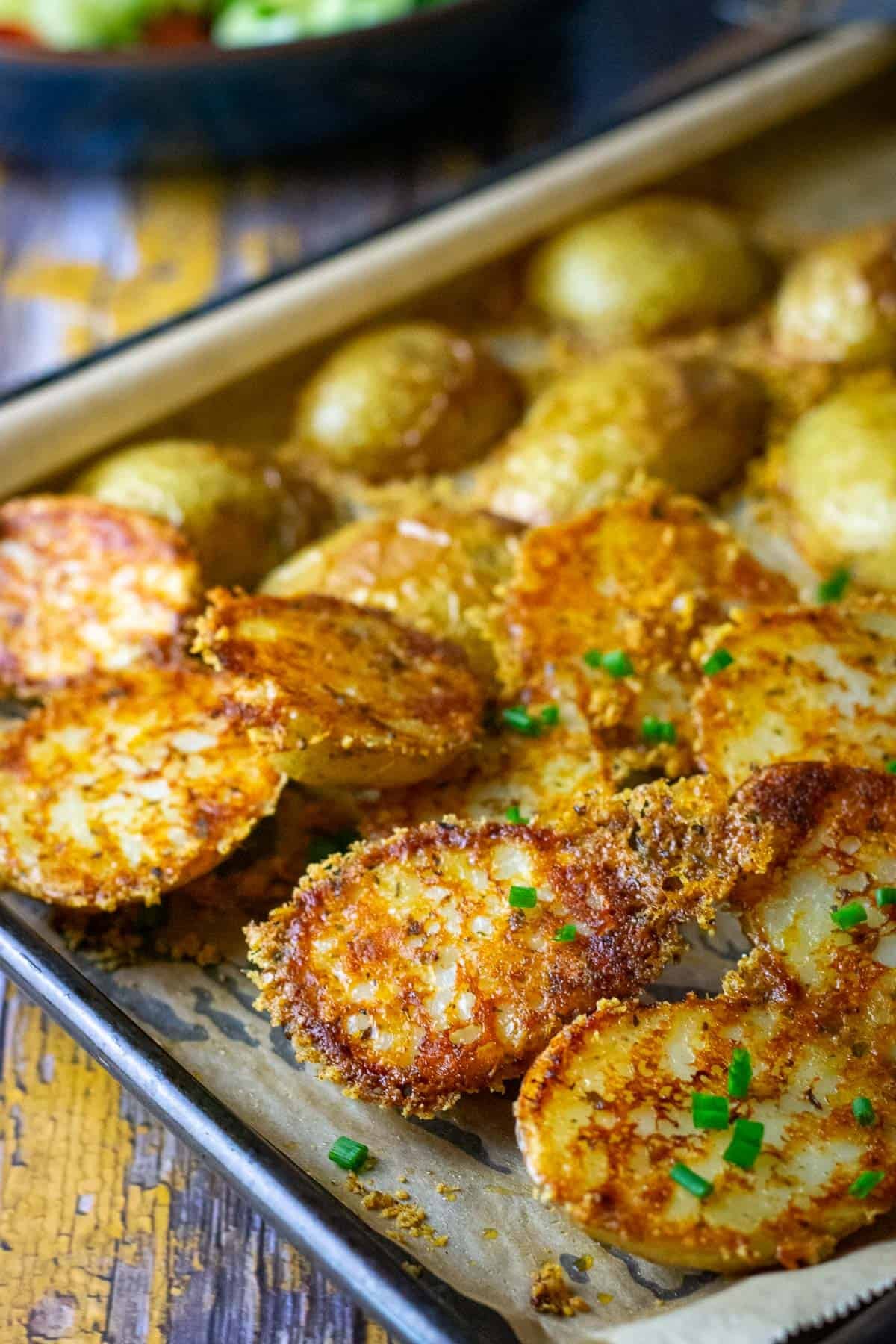 Roasted Baby Potatoes with Parmesan Cheese Crust with chives on top.