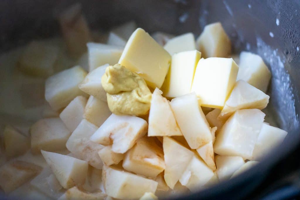 Boled celeriac with mustard and butter on top.