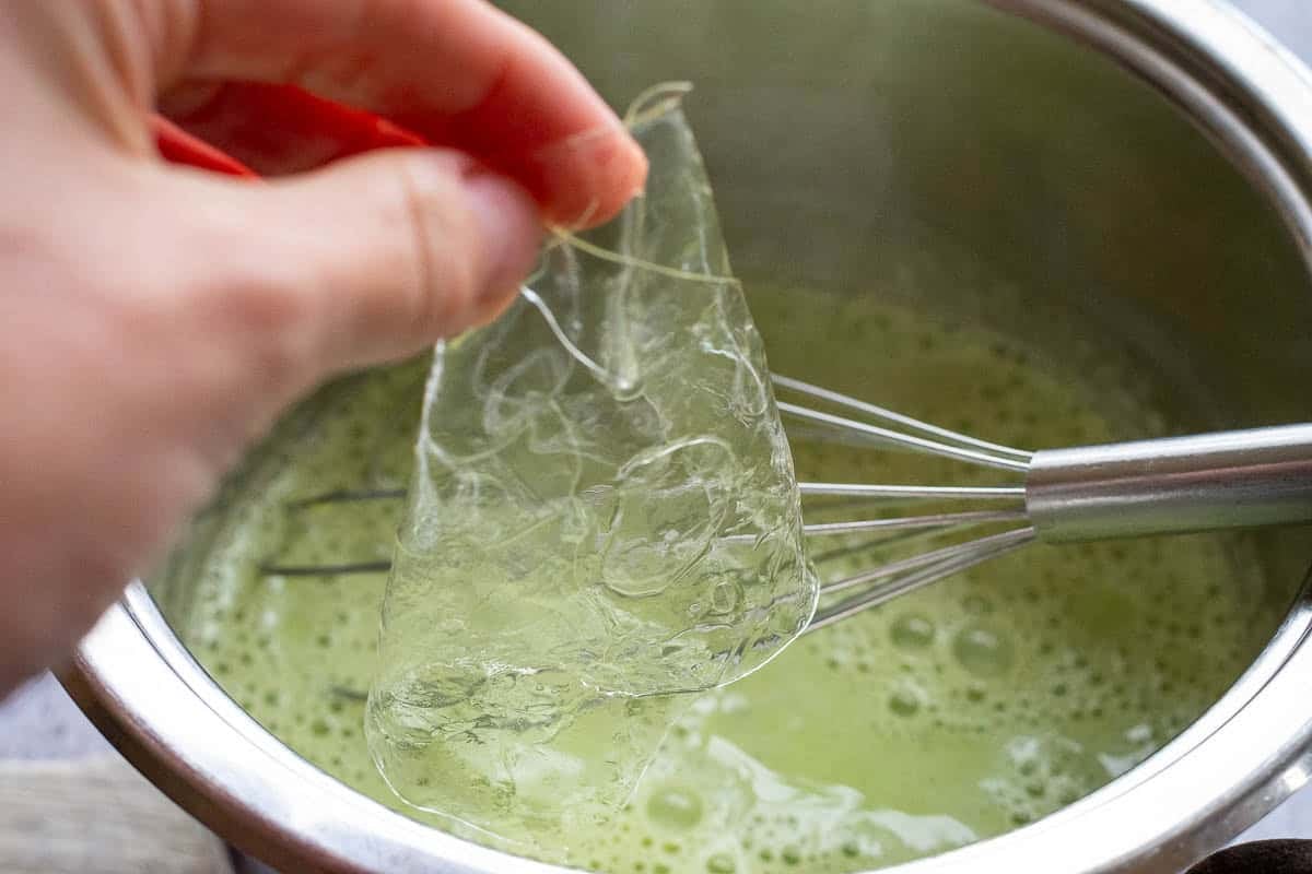 Adding soaked leaf gelatine to the matcha cream mixture.
