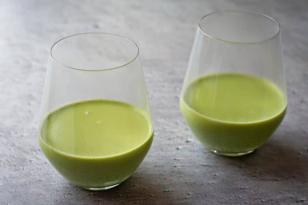 Matcha panna cotta poured into the glasses to set.