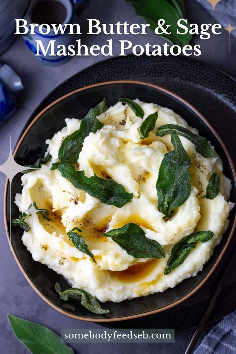 Brown Butter Sage Mashed Potatoes in a black bowl topped with crispy sage - Pin for Pinterest.