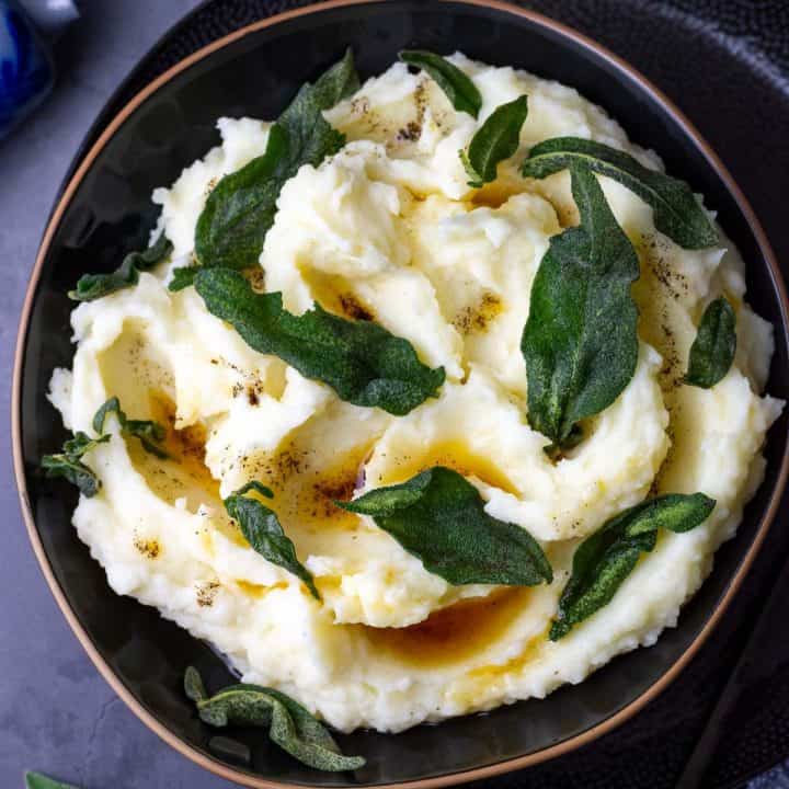Brown Butter Sage mashed potato in a black bowl.