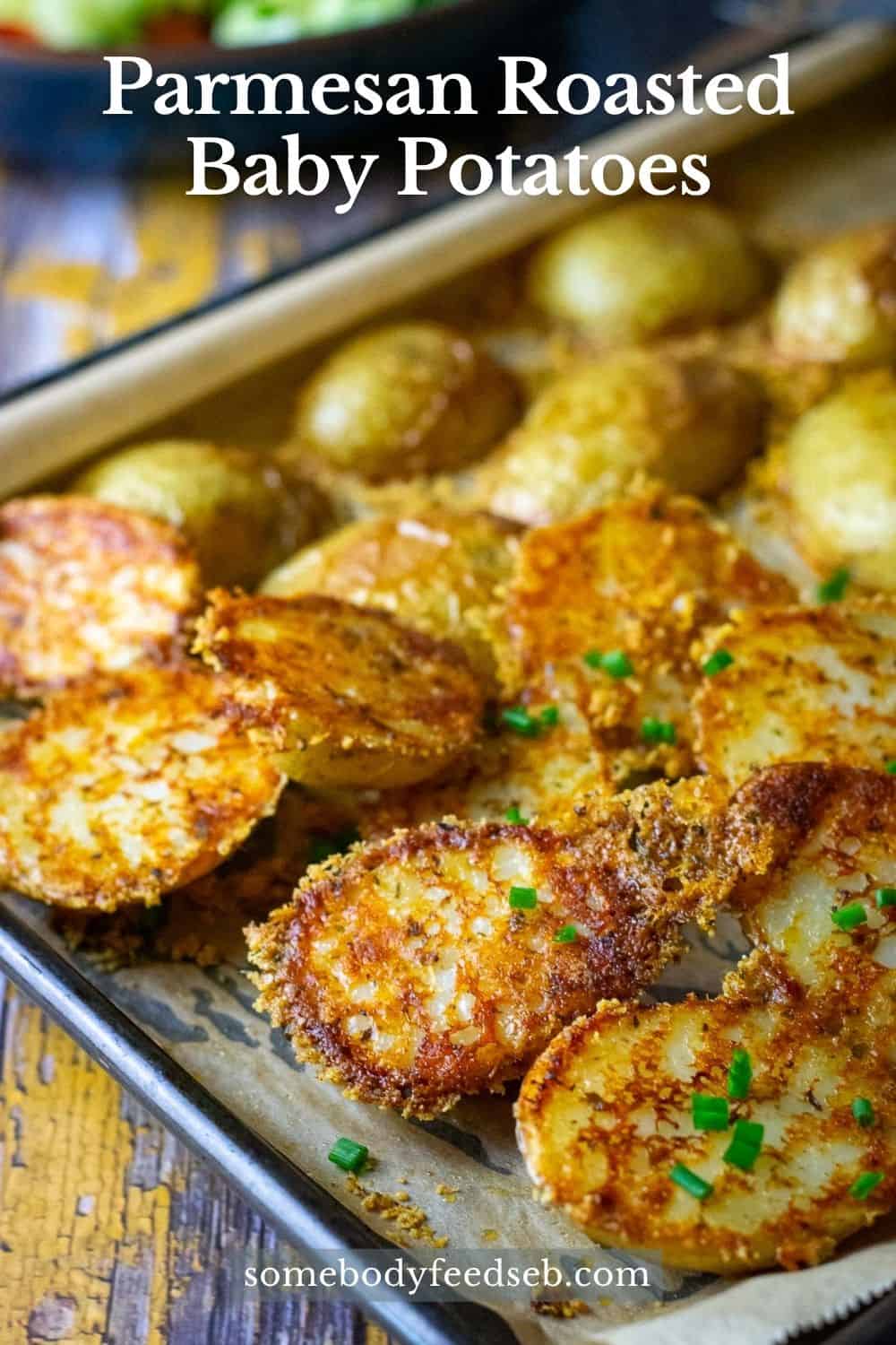Parmesan Roasted Baby Potatoes on a baking tray - Pin for Pinterest.