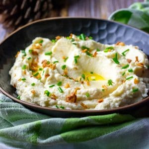 Celeriac mash garnished with crispy fried onions and chives.