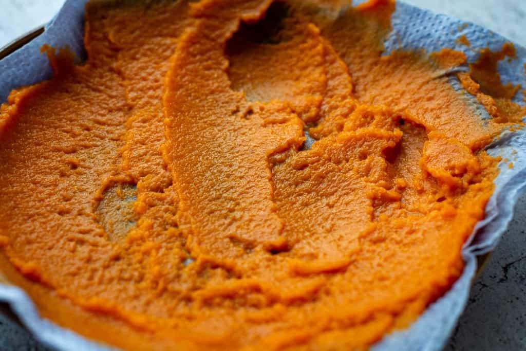 Pumpkin puree spread on paper towels to draw out excess moisture.