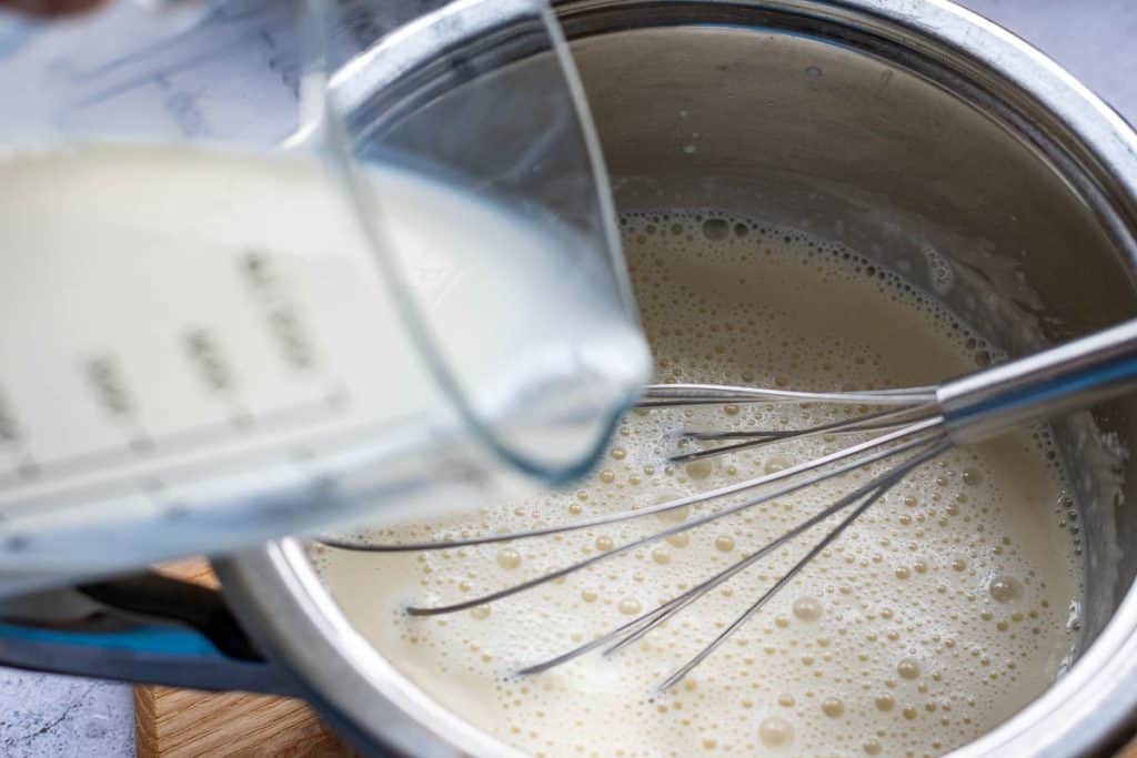 Milk gradually poured into the sourdough roux.