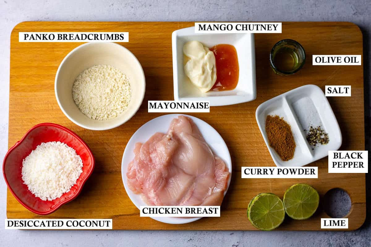 Ingredeints for Coconut Crusted Chicken on a wooden board.
