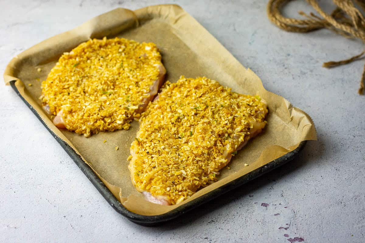 Coconut crsut on top of the chicken breasts ready to bake.