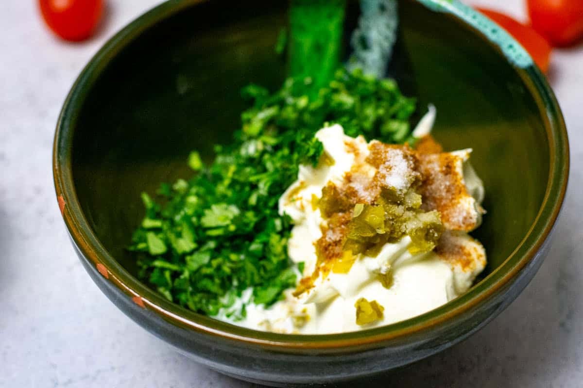 Sauce ingredients in a small dark green bowl.