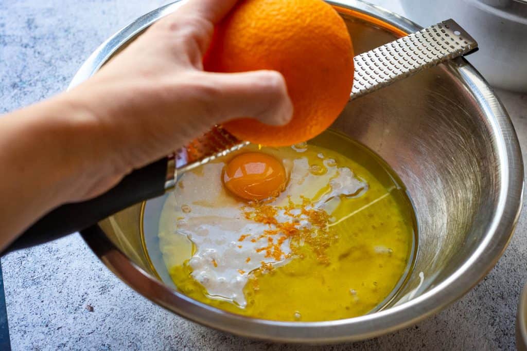 Using a microplane to zest an orange.