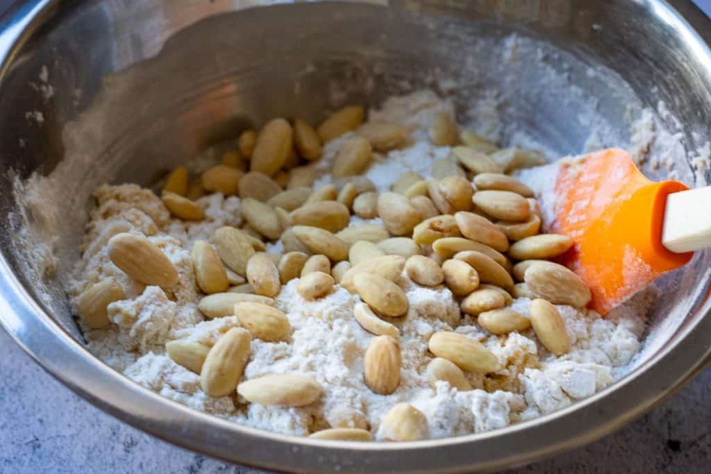 Folding blanched almonds into the sourdough biscotti dough.