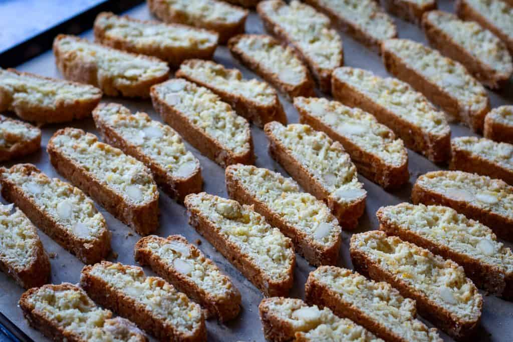 Sourdough Almond Biscotti arranged on a baking sheet lined with parchment paper for the second bake.