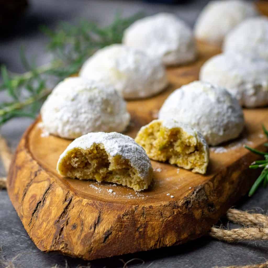 Sourdough snowball cookies on a wooden board.