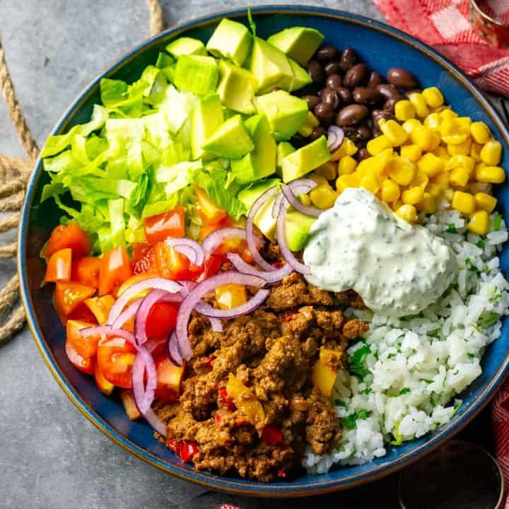 Chipotle spiced ground beef burrito bowl with lots of vegetables.