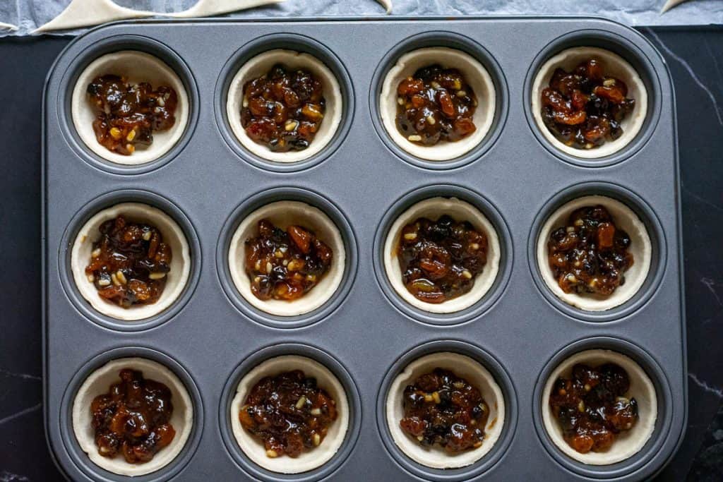 12 puff pastry cases with a spoonful of mincemeat in them.