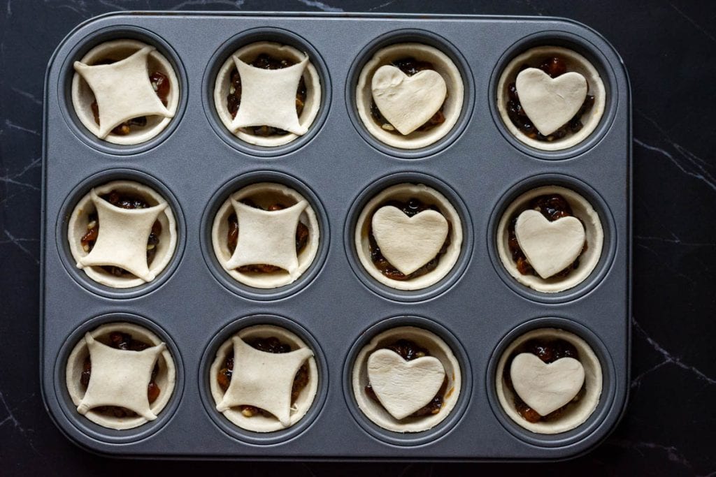 Assembled puff pastry mince pies ready to be baked.