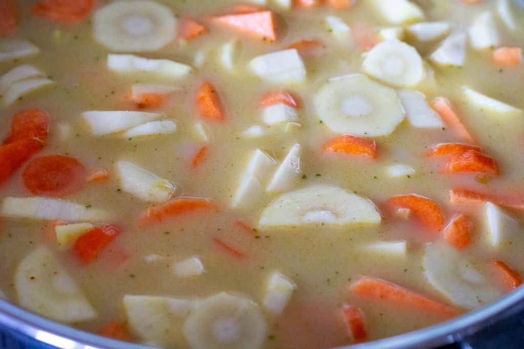 Vegetables simmering in a coconut milk and stock mixture.