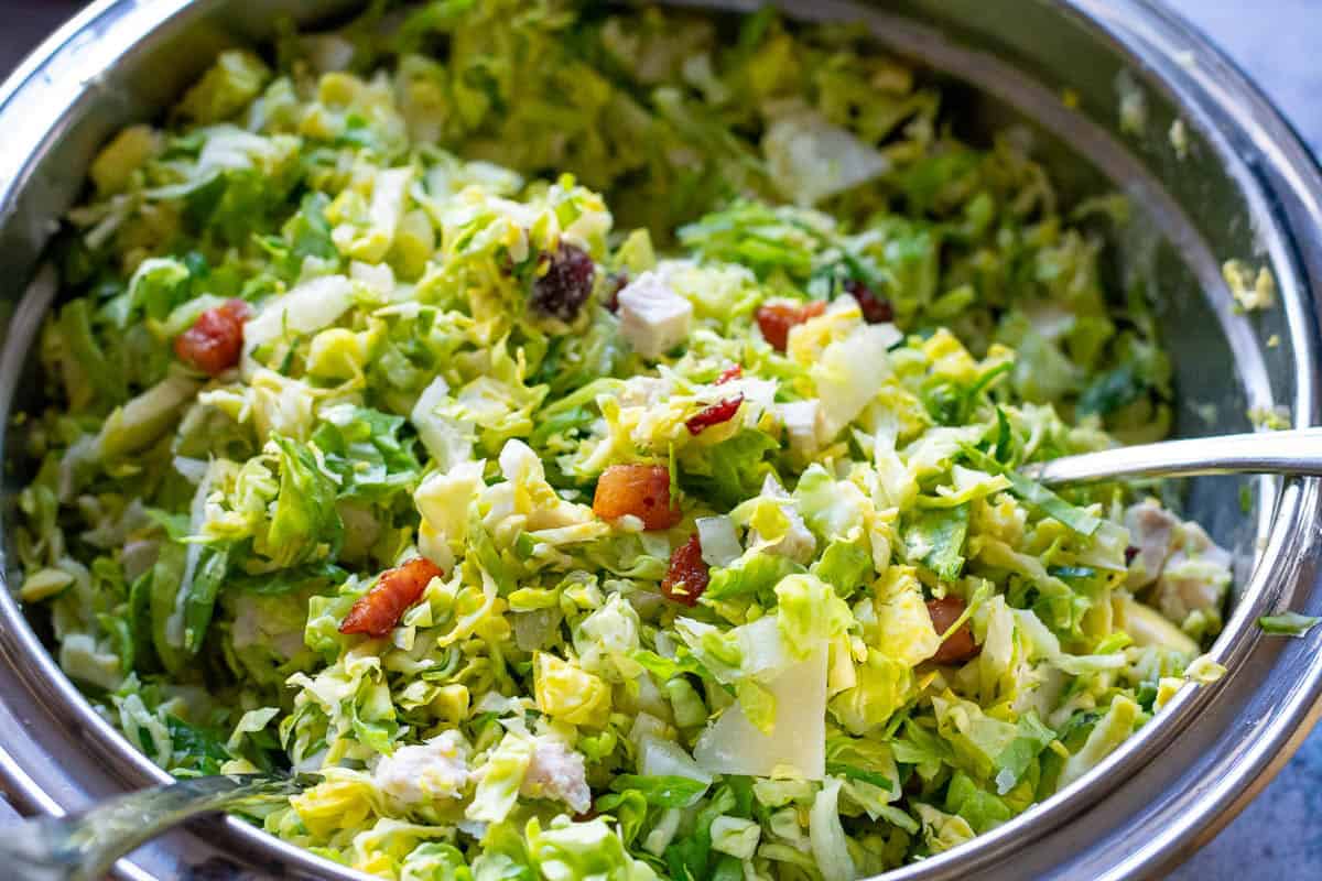 Mixed christmas caesar salad in a metal bowl.