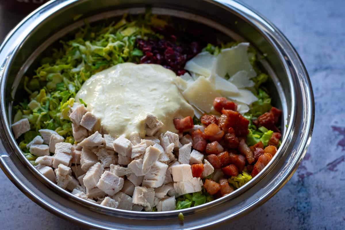 All Christmas leftover Caesar Salad ingredients in a large mixing bowl.