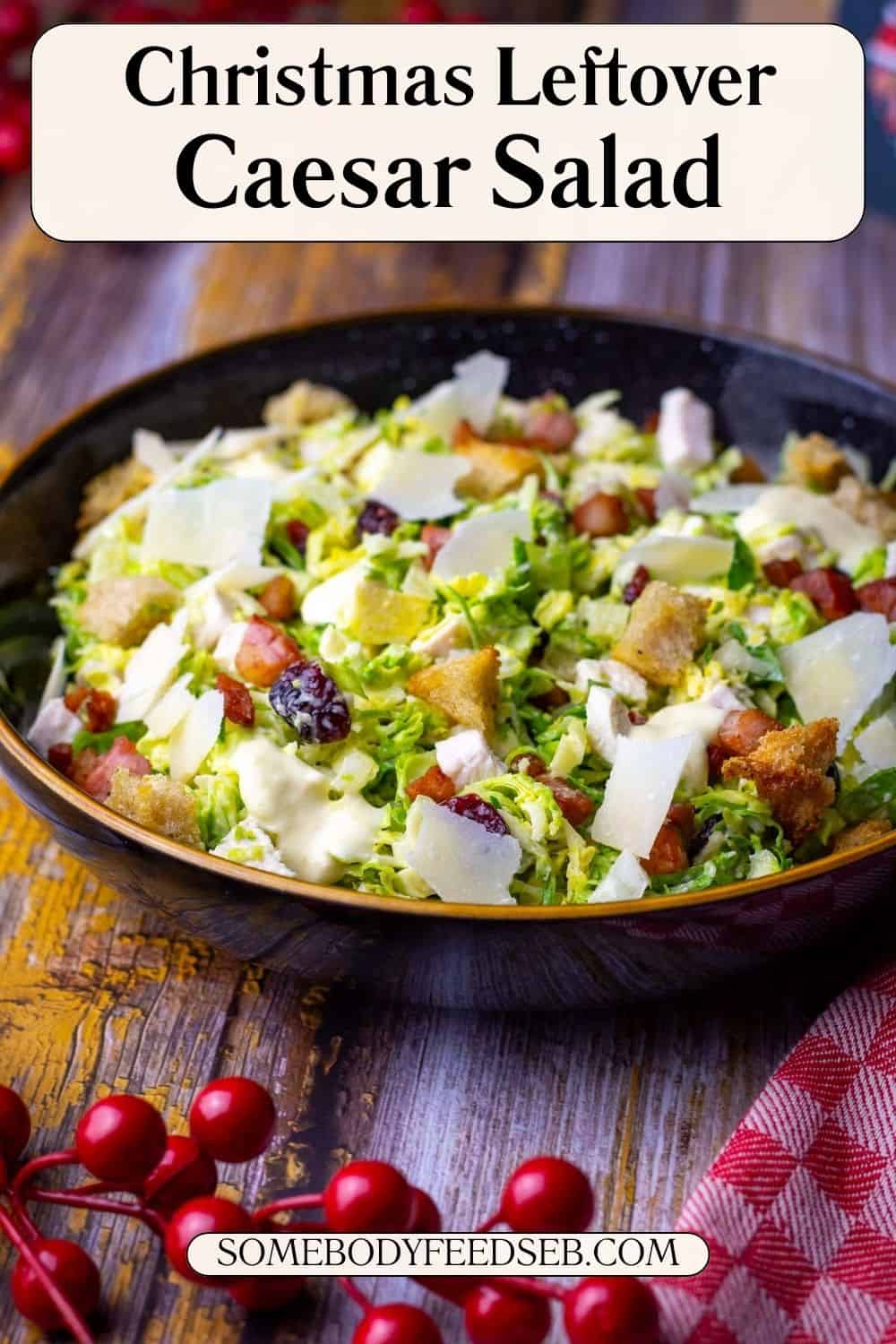 Christmas Caesar salad with Brussels sprouts and turkey in a black bowl - Pin for Pinterest.